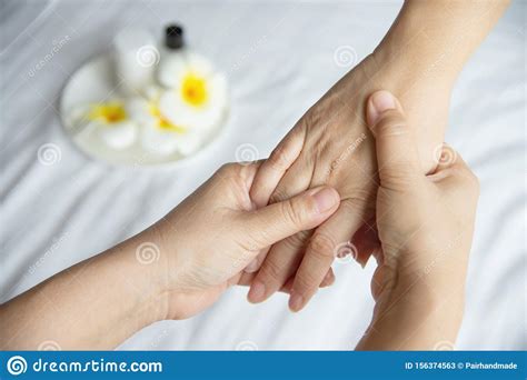 hand spa massage over clean white bed background stock