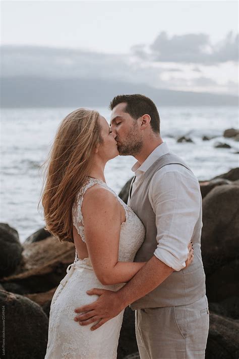 view couple kissing at beach wedding by stocksy contributor leah