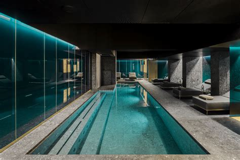 indoor swimming pool surrounded  glass walls