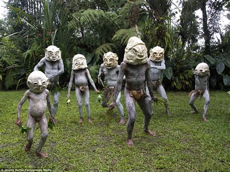 mud men of papua new guinea pictured in their clay masks daily mail online