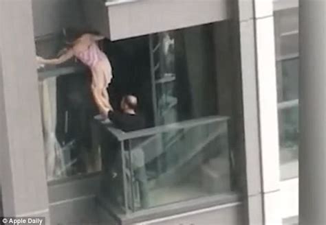 hong kong wife risks her life on a ledge to clean windows daily mail online