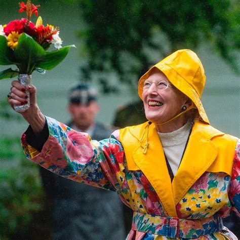 woman  yellow raincoat holding flowers