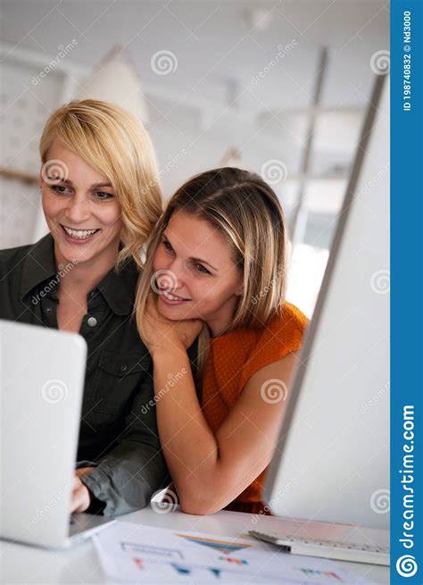 Happy Lesbian Couple Planning Brainstorming At Startup In Office Stock