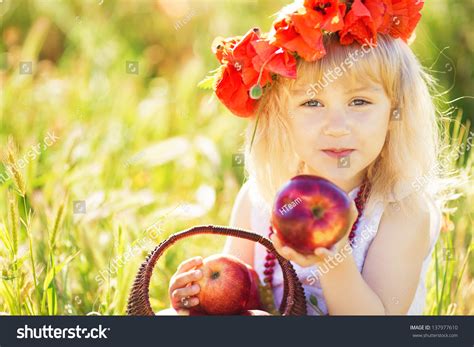 Cute Blonde Girl Playing In Poppy Field With Wreath On Her Head Stock