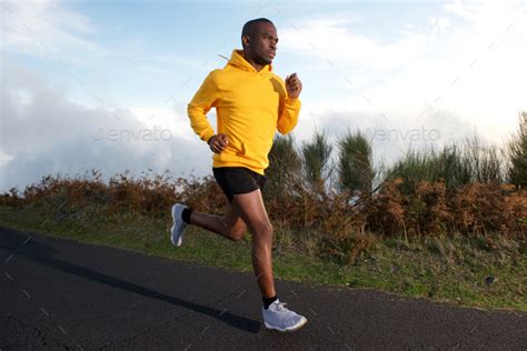 fit young black guy running  street stock photo  mimagephotography