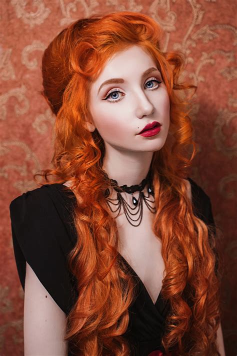 Portrait Of A Woman With Long Red Curly Hair In A Black