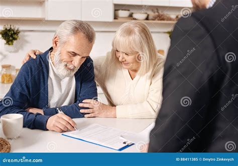 charming cute elderly couple signing documents  home stock image