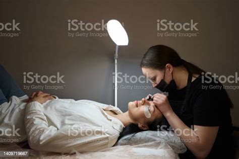 Eyelash Extension Artist Bent Over A Client On A Couch Spinal Diseases