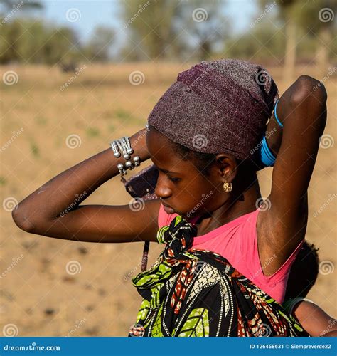 Unidentified Fulani Girl Ties A Headscarf On Her Head Fulanis
