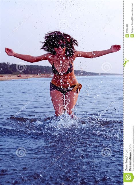 girl splashing in baltic sea water royalty free stock
