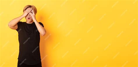 Free Photo Portrait Of Embarrassed Asian Guy With Blond Hair Gasping