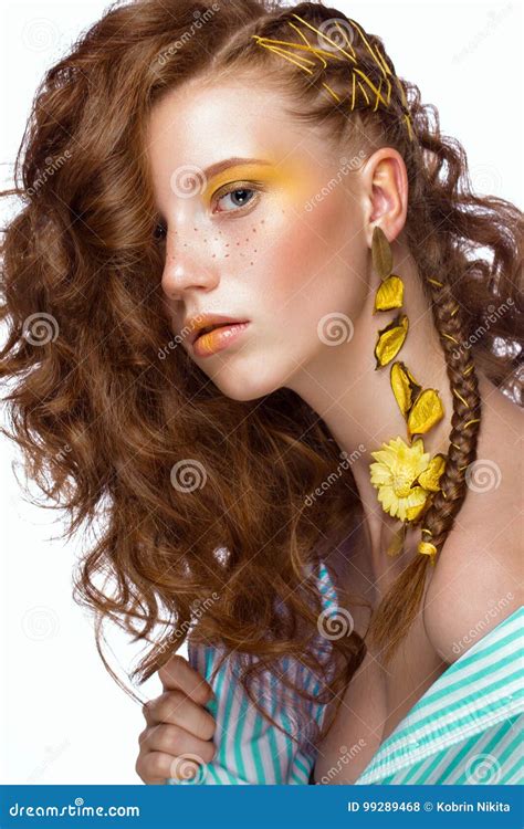 portrait of beautiful red haired girl with brightly colored art makeup