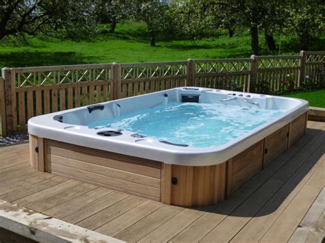 hot tub sitting  top   wooden deck    lush green field