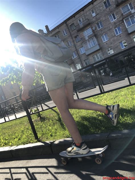 Girl In Denim Shorts On Skateboard Street Candid Photos