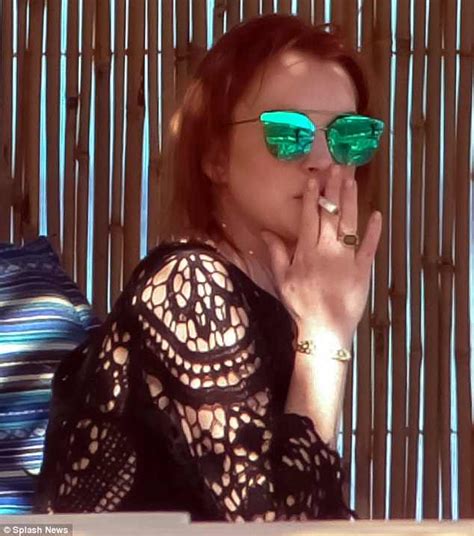 Lindsay Lohan Enjoys Cigarette As She Steps Out Her Car In Mykonos