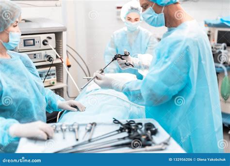 surgeon holding laparoscopic instrument  operating room stock photo image  laparoscope