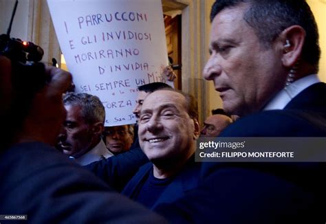 Silvio Berlusconi Surrounded By Bodyguards Smiles As He Arrives At
