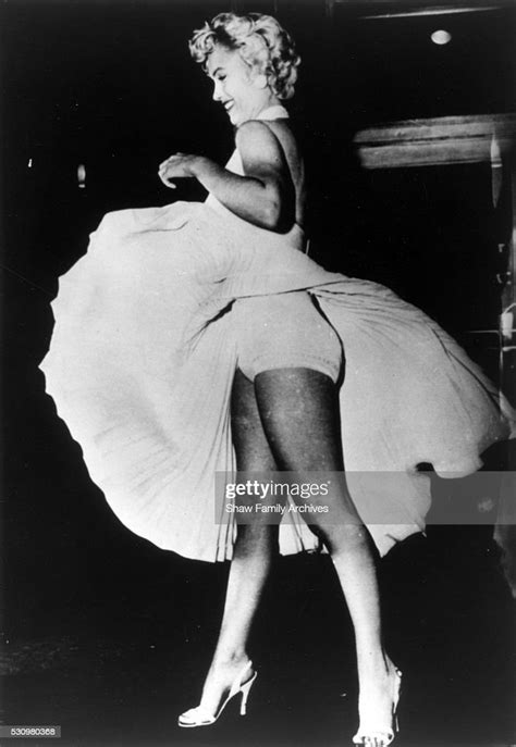 marilyn monroe with the skirt of her white dress blowing as she news