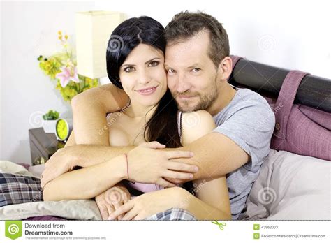 Beautiful Happy Couple In Love Smiling Hugged In Bed Stock