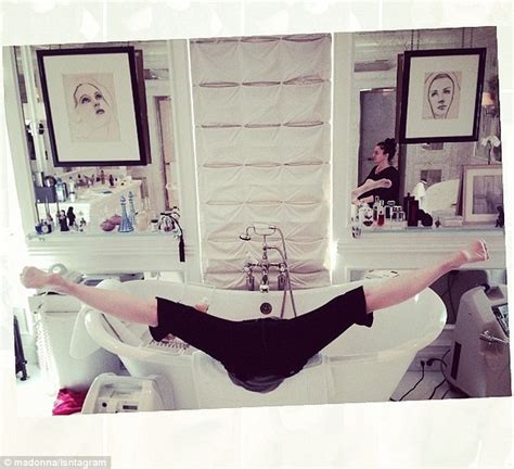 madonna goes head over heels to perform gymnastic splits in a bathtub