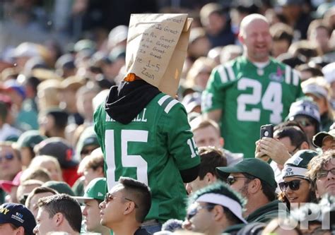 photo   york jets fan stands   paper bag   head