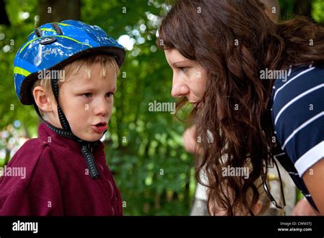 Polish Son Wearing A Helmet Intently Talking To His Mom Age 8 And 32