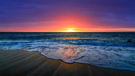nice beautiful ocean waves beach sand  purple red clouds sky background  sunset hd beach