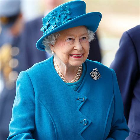 queen elizabeth wearing a blue coat and hat popsugar fashion