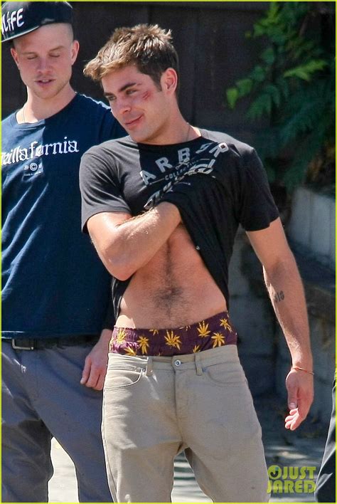zac efron lifts up his shirt and gives us the t of his