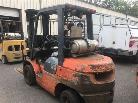 orange toyota fgu lbs  stage solid tire propane forklift  headache rack  auctions