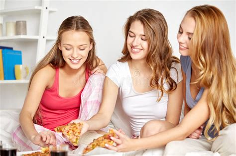 happy friends or teen girls eating pizza at home stock image image of girlfriend happy 68436603
