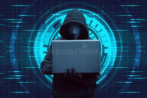hooded hacker typing  laptop  standing stock photo image
