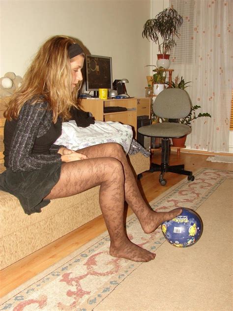 candid woman wearing fashion pantyhose with her foot on a football pantyhose with nylon feet