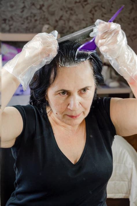 mature woman dying  hair  front  mirror woman  brush  hair dye coloring  hair