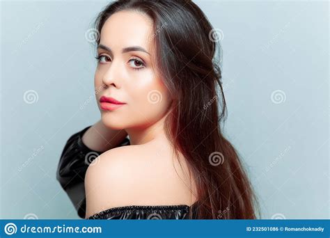 Portraits Of A Beautiful Brunette Model Who Stands Sideways And