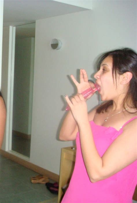 cute girls playing with condom in mouth