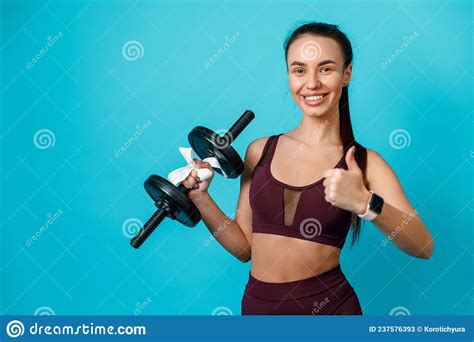 Fit Brunette Woman Holding Dumbbells With Ribbon And Showing Thumb Up