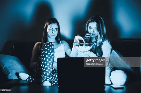 Roommates Lesbian Couple Watching Movie On Laptop At Home In Livingroom