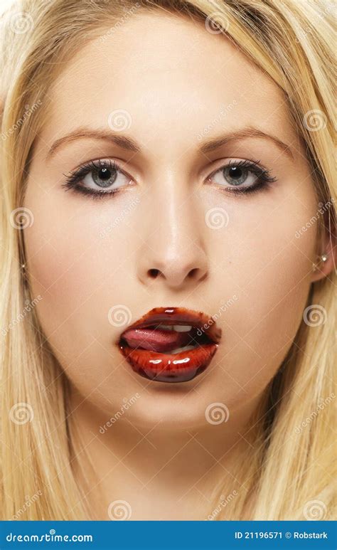 beautiful blonde woman licking chocolate from her stock image image