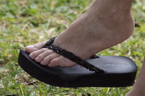long bare toes in black flip flop dangle by feetatjoes on deviantart