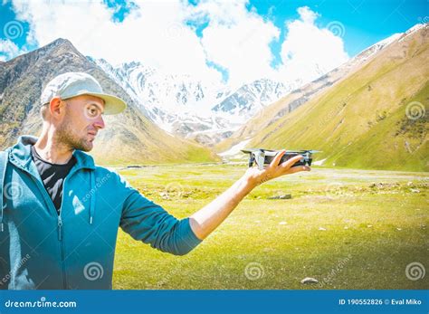male person holds  drone stock photo image  green