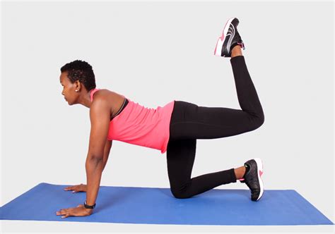 fit african woman  donkey kick exercise