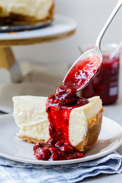 classic baked cheesecake  easy berry sauce simply delicious