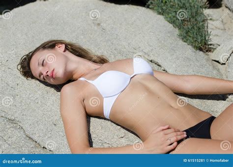 woman  lying   sunbathing  solid rocks stock image image