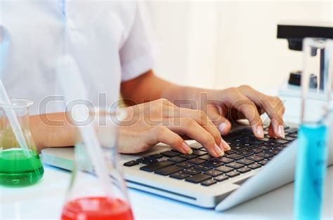 scientist typing documents  laptop stock image colourbox