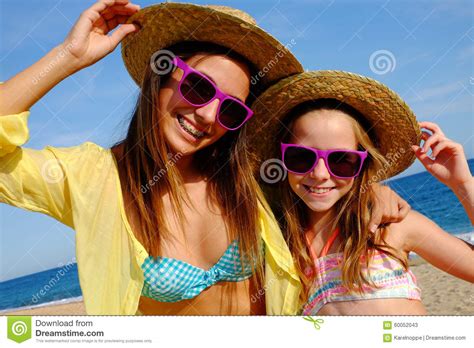 Happy Girlfriends On Beach With Hats And Sunglasses Stock Image