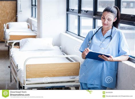 nurse writing on a clipboard stock image image of adult