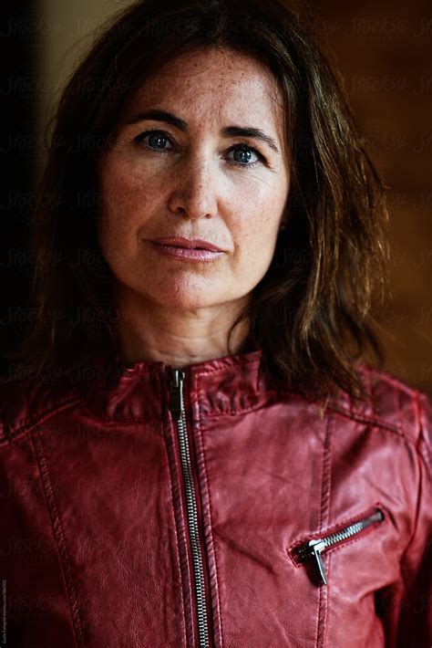 mature brunette in red leather jacket by stocksy contributor guille