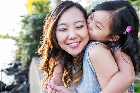 happy asian girl kissing her mother by take a pix media
