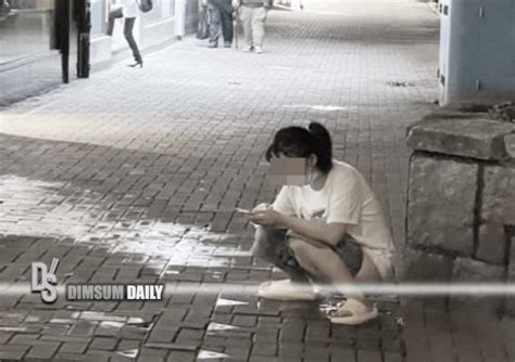 woman plays with mobile phone while urinating in public on sai wan ho